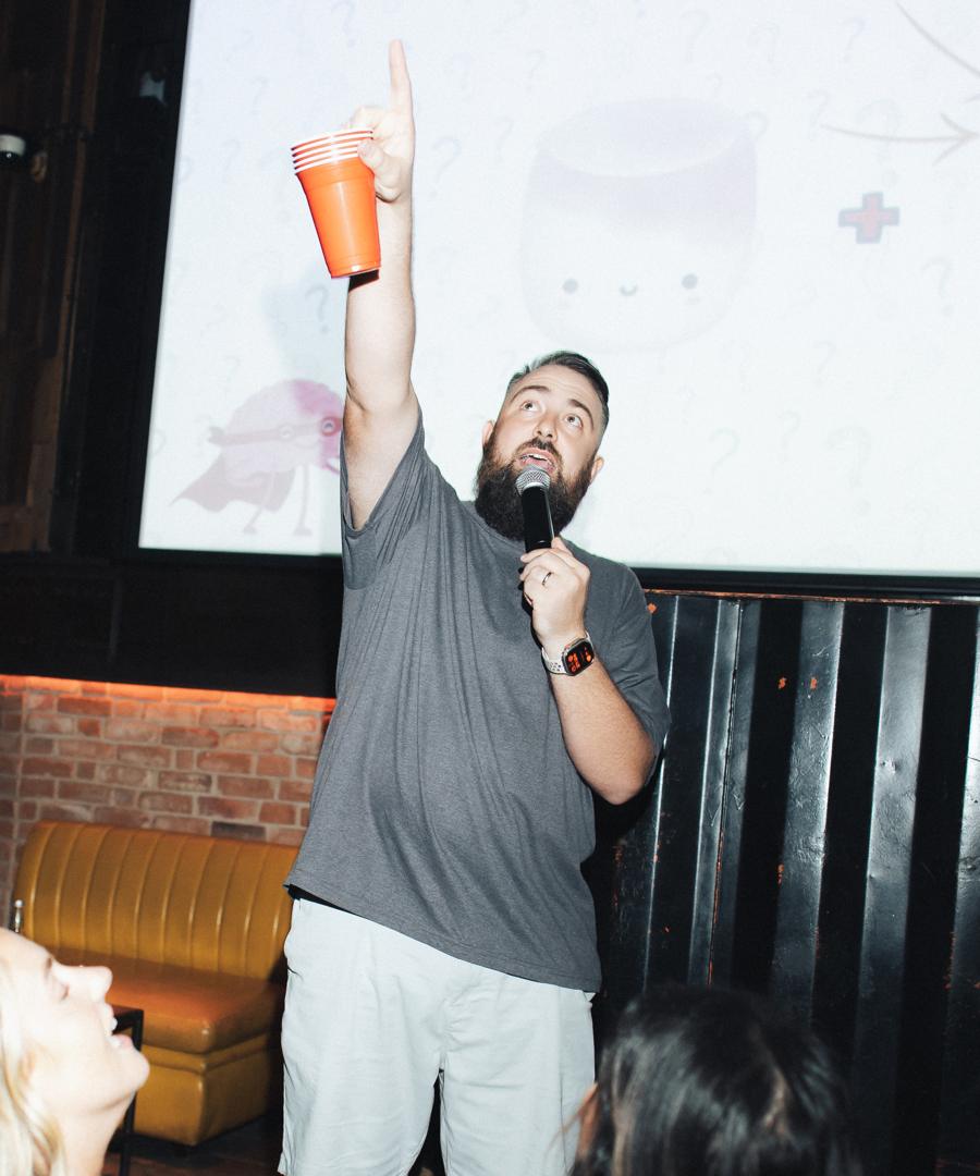 Quizman Dan hosting live in front of the quiz screen